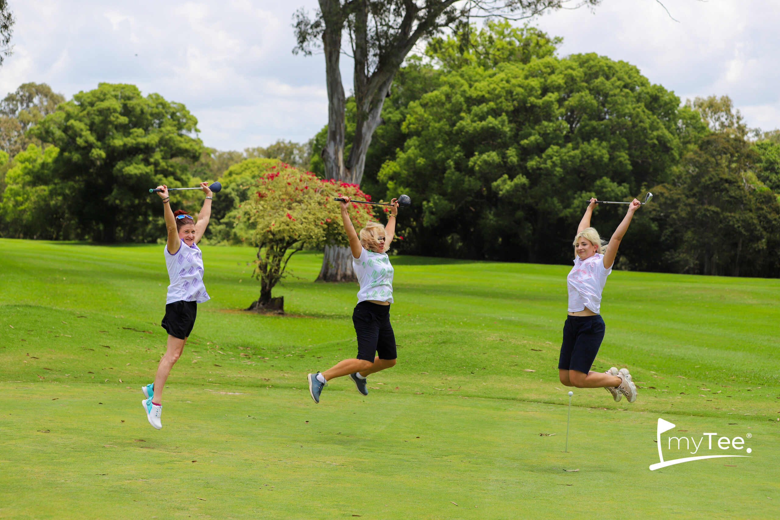 4 women golfers jumping